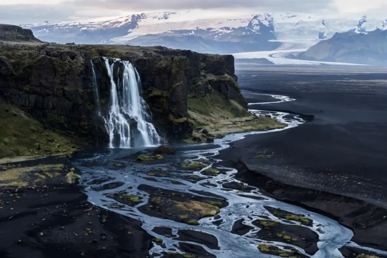 Holidays to Iceland from UK — waterfall on Iceland south coast with glacier mountains